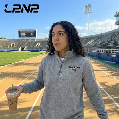Carbon Grey fleece pullover with soft interior, relaxed fit, and ribbed cuffs for track and field warmth