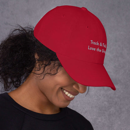 Low-profile Track and Field hat with adjustable strap and curved visor in green camo color