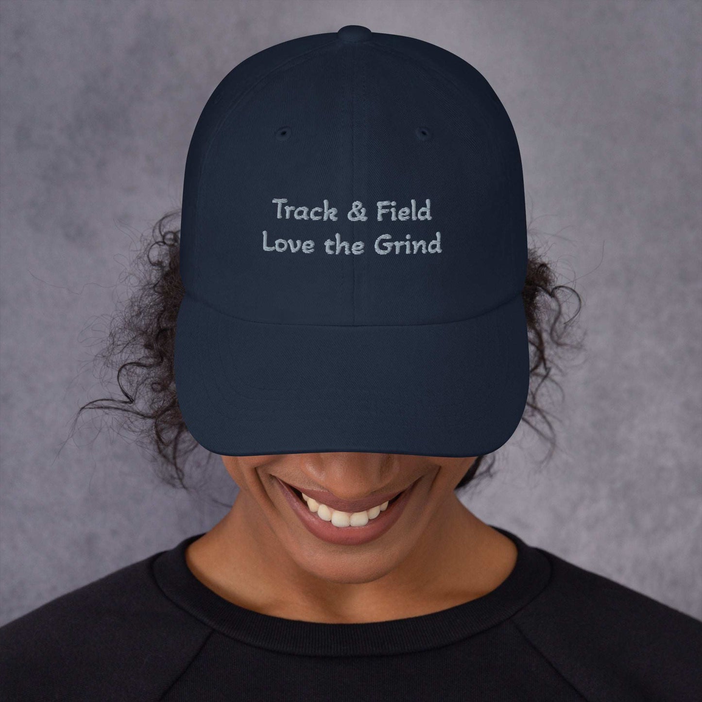 Low-profile Track and Field hat in green camo with adjustable strap and curved visor