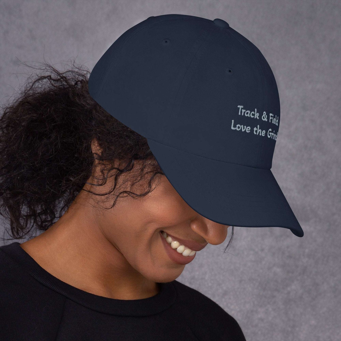 Low-profile green camo Track and Field hat with adjustable strap and curved visor