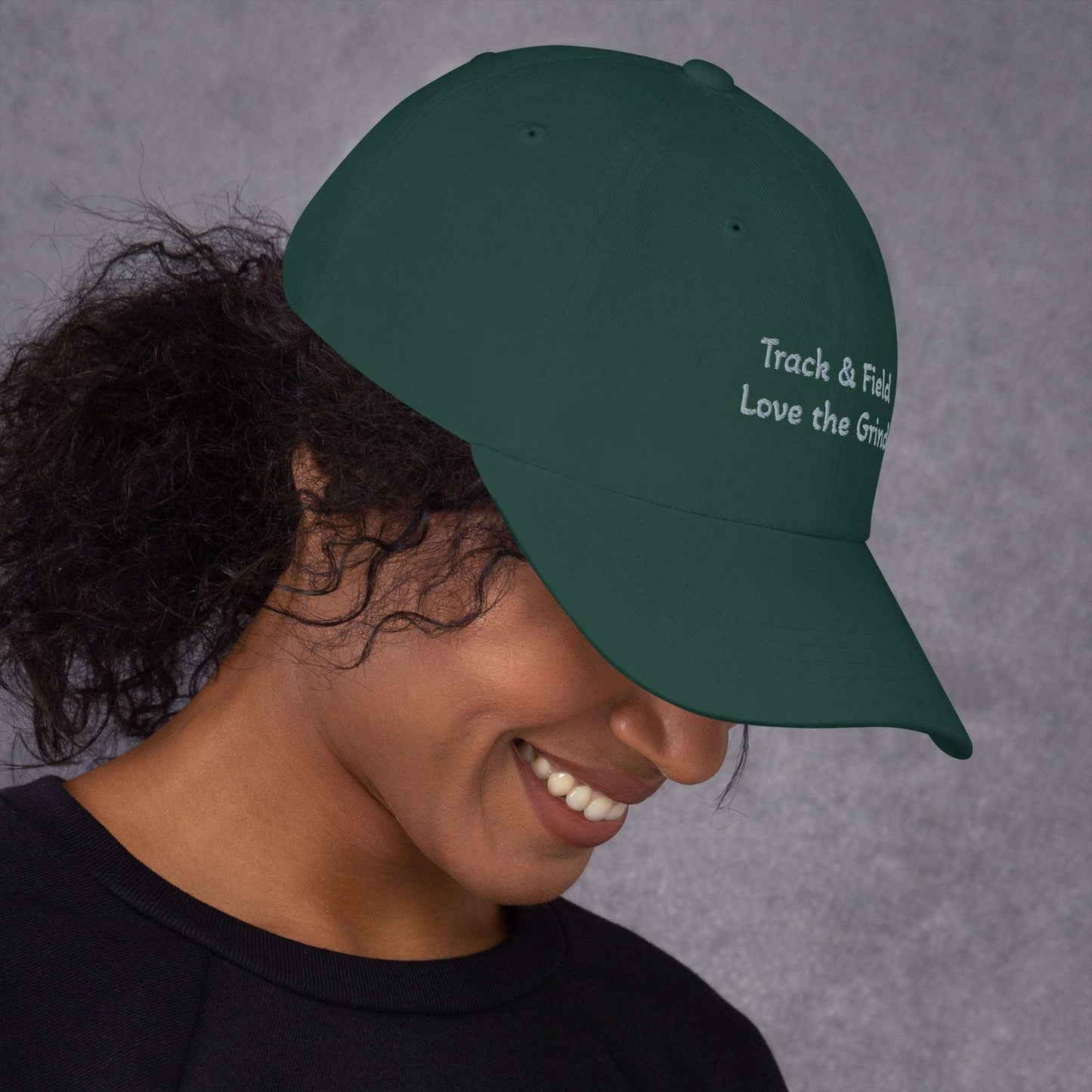 Green camo Track and Field hat with low profile, adjustable strap, and curved visor