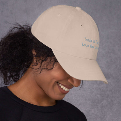 Green camo Track and Field hat with adjustable strap and curved visor